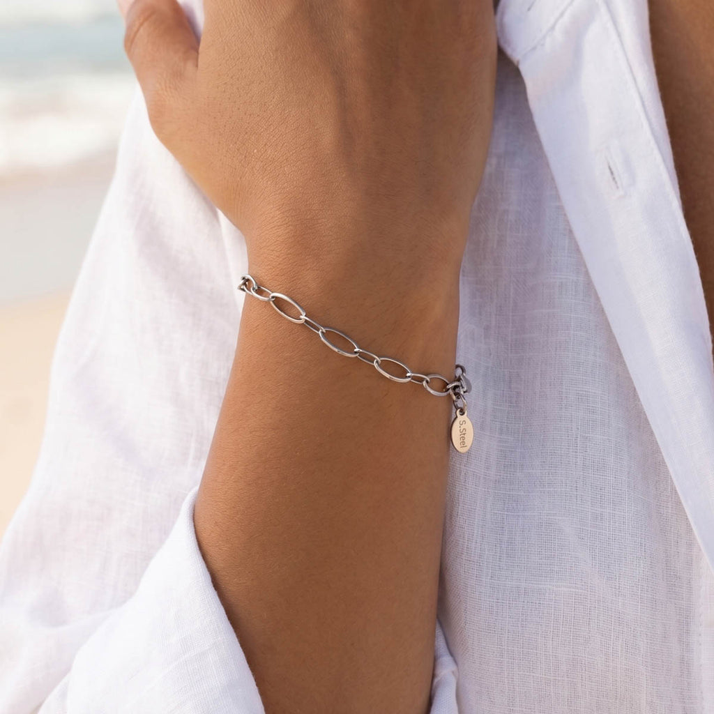 Silberfarbenes Damen Armband am Handgelenk eines Models getragen.