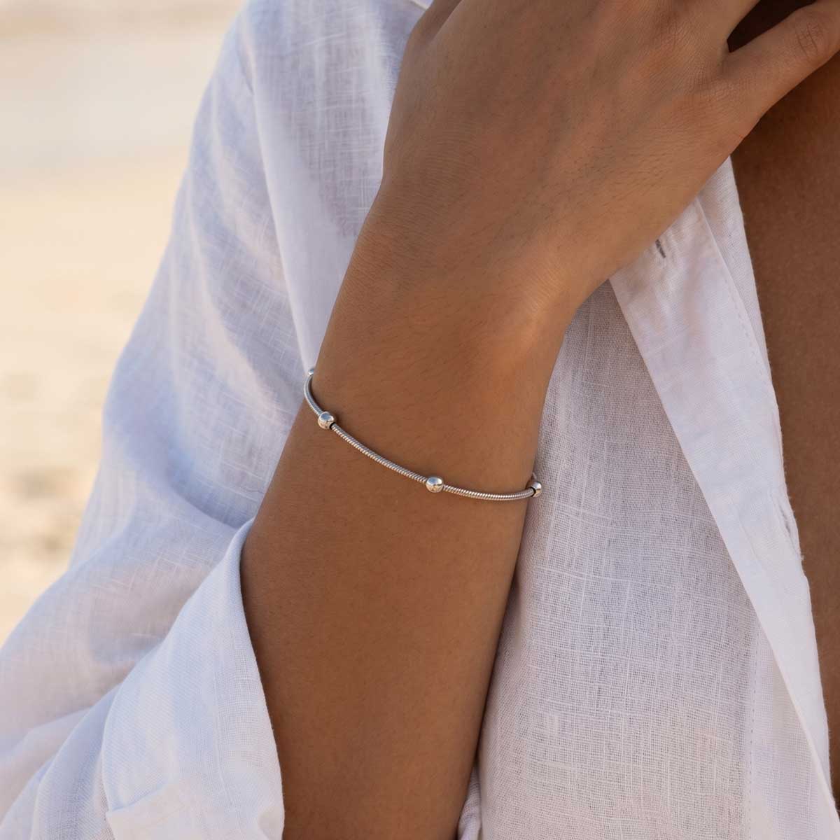 Silberfarbenes Damen Kugel Armband am Handgelenk eines Models getragen.