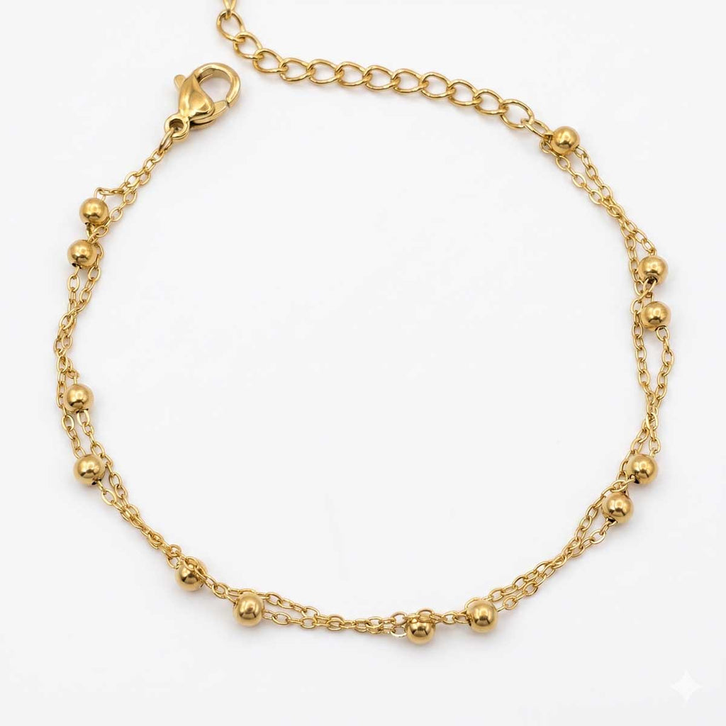 Zweireihiges goldfarbenes Edelstahl-Armband für Damen mit filigranen Kugel-Elementen, Hauptfoto.