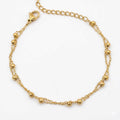 Zweireihiges goldfarbenes Edelstahl-Armband für Damen mit filigranen Kugel-Elementen, Hauptfoto.