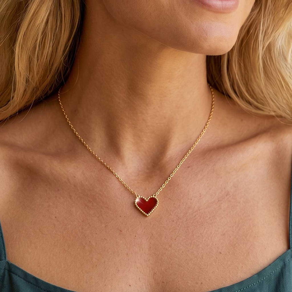 Goldfarbene Damen Halskette mit Herz Anhänger am Hals eines Models getragen.
