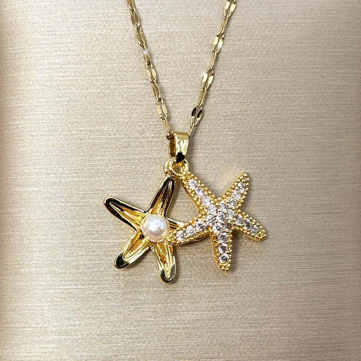 Goldene Halskette mit maritimem Seestern-Anhänger und funkelnden Zirkonia-Steinen, offen gelegt.